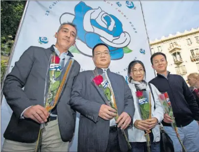  ??  ?? DE ESTRENO Y CON LA ROSA. Chen Yansheng observa la cámara de AS en el ‘stand’ del Espanyol por Sant Jordi en el centro de Barcelona.