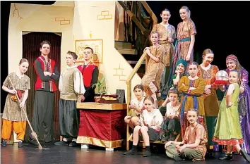  ?? ?? Cast members Grace Patterson, Roy Barake, Ethan Smith, Toby Fairess (left) Marissa Demicoli, Aisha Smith, and Jules Perry as the “beggars” (bottom step) Lucy Blackmore, Lillie Price, Maya Robinson, Claudia Frendo (middle step), Ella Lecher (floor), Adelaide Sayer, Rachel Baker, Joey Kiraly as the “Show Owner” Cassandra Hector as the “Fortune Teller”.