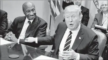  ?? Ron Sachs Pool/Getty Images ?? MERCK’S Kenneth C. Frazier, left, with President Trump in 2017. Merck has announced a 60% cut in the price of its hepatitis C drug that’s an also-ran in the shrinking market for hepatitis C cures.