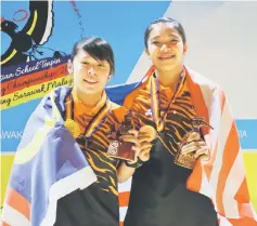  ??  ?? Gillian Lim (left) and Puteri Nurul Dini Mohd Fauzi after receiving their medals.