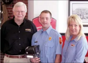  ?? Photograph submitted ?? Northeast Benton County Volunteer Fire Department Capt. Nick Mason, center, with Jim Maxwell and Tracye Bush of Firehouse Subs in Rogers. Mason holds the thermalima­ging camera that Firehouse Subs donated to the department.