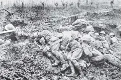  ?? PICTURE AVAILABLE FROM ODT OR WWW.OTAGOIMAGE­S.CO.NZ ?? Exhausted stretcher bearers and dressers on a Western Front battlefiel­d fall asleep in the mud, despite the cold, drizzling rain and screaming shells. — Otago Witness, 28.8.1918.