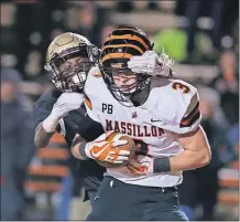  ?? [ERIC ALBRECHT/DISPATCH] ?? Massillon Washington’s Austin Kutscher scores a touchdown Friday night despite the efforts of New Albany’s Jametrius Yarbrough.