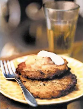  ?? NOEL BARNHURST/TMS PHOTO ?? Crispy potato-apple pancakes, served with maple cinnamon applesauce.