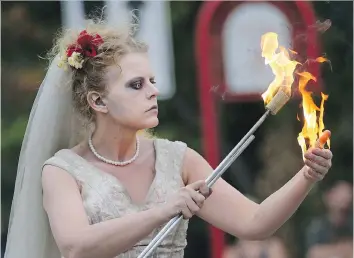  ?? PHOTOS GREG PENDER ?? Tara from the Undead Newlyweds performs with fire during Thursday’s opening evening of the 2016 PotashCorp Fringe Theatre and Street Festival on Broadway Avenue.