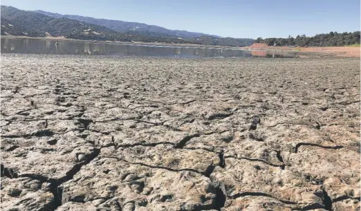  ?? HAVEN DALEY/AP ?? An exposed dry bed is seen at Lake Mendocino near Ukiah, California. The drought-stricken town of Mendocino gets some of its water from the reservoir.