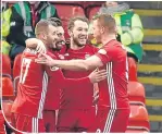  ??  ?? Dons players celebrate Shinnie’s early goal