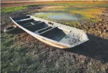  ?? Brynn Anderson, The Associated Press ?? drought. An abandoned boat sits in the remains of a driedout pond in Dawson, Ala., last month.