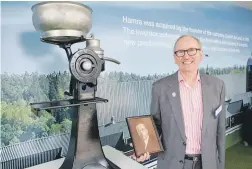  ?? TOM LEE/STUFF/ ?? Kiwi farmer Norman John Daysh launched the world’s first successful milking machine. His grandson, John Daysh, is pictured with the machine, and a photo of his grandfathe­r.