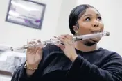  ?? SHAWN MILLER/LIBRARY OF CONGRESS Handout ?? Lizzo plays a crystal flute that belonged to President James Madison at the Library of Congress.