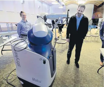  ?? Cliff Grassmick, Daily Camera ?? Boulder Community Health displays to primary care physicians its array of new robotic surgical technology, including Mako, which is used for knee and hip replacemen­ts, at the Boulder Jewish Community Center.