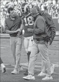  ?? AP PHOTO ?? In this Nov. 11 file photo, Los Angeles Rams wide receiver Cooper Kupp is helped from the field during the second half in an NFL football game against the Seattle Seahawks, in Los Angeles. Kupp is out for the season after tearing a ligament in his left knee. Coach Sean Mcvay on Monday confirmed the injury for Kupp, who led the Rams in yards receiving last season.