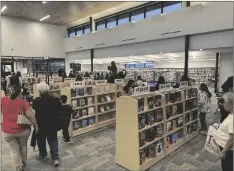  ?? ELIZABETH MAYORAL CORPUS PHOTO ?? Members of the public peruse the stacks of books and its different sections for their favorite literary titles during Opening Day, Nov. 10, in El Centro.