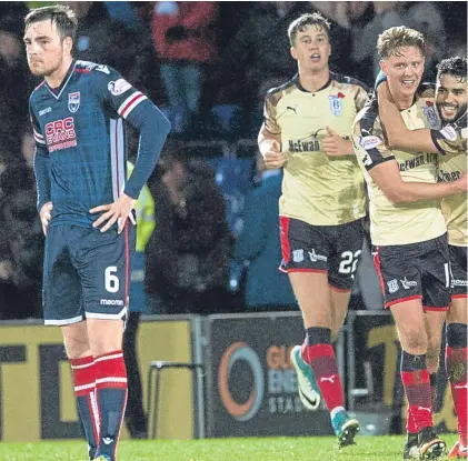  ??  ?? Above: Dundee’s scorers Mark O’Hara and Faissal El Bakhtaoui celebrate together after the striker had lobbed in the second and clinching goal; below: Jack Hendry shows the determinat­ion on display by the visitors as he holds off County’s Craig Curran.