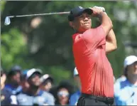  ?? AFP TENNIS ?? Tiger Woods tracks his tee shot on the fourth hole during Sunday’s final round of the Wells Fargo Championsh­ip.