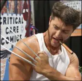  ??  ?? An convention­eer dressed as Wolverine shows off his costume props Saturday at the Amazing Las Vegas Comic Con at the Las Vegas Convention Center.