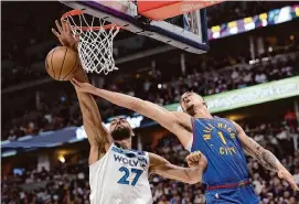  ?? Matthew Stockman/Getty Images ?? In trading for Rudy Gobert, left, the Timberwolv­es put their focus on defense in an era where teams have focused more on speed and perimeter shooting.