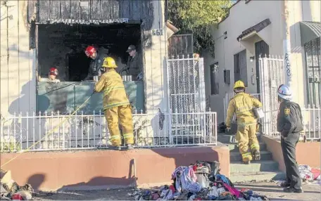  ?? Irfan Khan Los Angeles Times ?? THE MOTHER had left the home briefly and returned to find it in flames, said a fire official, who added that when the firefighte­r found the children, they were “nearly lifeless.” Investigat­ors are trying to determine the cause of the blaze, which left...