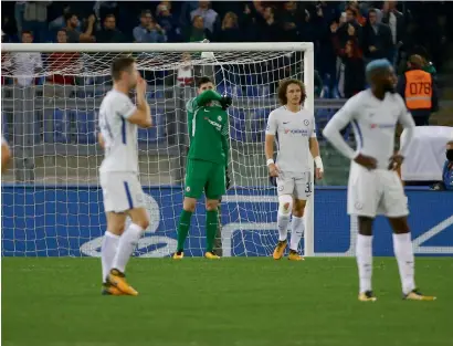  ?? Reuters ?? Chelsea’s David Luiz, Thibaut Courtois and teammates look dejected after conceding a goal against AS Roma during the Champions League match.—