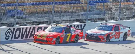  ?? THE ASSOCIATED PRESS ?? Justin Allgaier races in front of Christophe­r Bell during Sunday’s NASCAR Xfinity Series race at Iowa Speedway in Newton, Iowa. Allgaier won the race after winning all three stages, and Bell finished in second place.