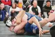  ?? Brian A. Pounds/Hearst Connecticu­t Media ?? New Milford’s Khalil Bourjelli pins Newington’s Zachary Whit to win the 160-pound weight class at the CIAC Class L wrestling championsh­ip on Saturday in Guilford.