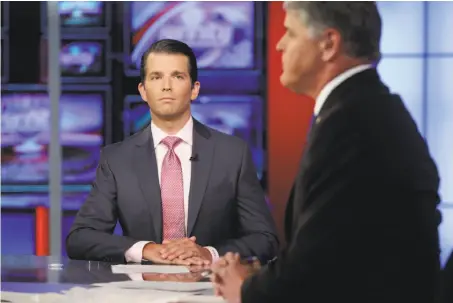  ?? Richard Drew / Associated Press ?? Donald Trump Jr. (left) told Sean Hannity on Fox News on Tuesday that “I probably would have done things a little differentl­y.”