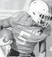  ?? TIM BROGDON/MIAMI ATHLETICS ?? Hurricanes wide receiver Keyshawn Smith makes a catch and run during spring drills.