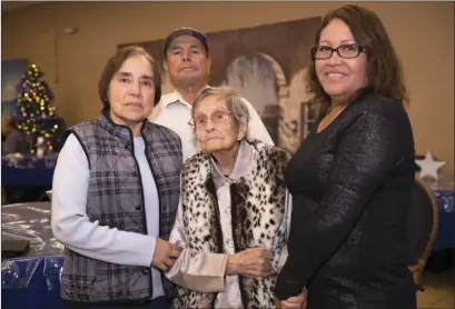  ??  ?? ABOVE: Natalia Lopez, age 110, poses with her granddaugh­ter Lila (right) along with other family members at the El Centro Day Out Adult Day Care Center on Thursday afternoon.