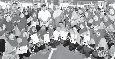  ??  ?? RINA (berdiri tengah) bergambar bersama usahawan tempatan pada Program Menyantuni Tranformas­i Luar Bandar anjuran Persatuan Usahawan Muslimah Johor di Sport Prima Pandan di Johor Bahru, semalam. — Gambar Bernama