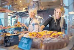  ?? EDDIE MOORE/JOURNAL ?? Anne-Laure Ligier, left, co-owner of Clafoutis, and Charlotte Kolkmeyer serve items from the bakery at Clafoutis earlier this week.