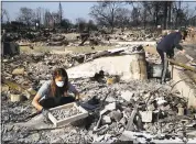  ?? JAE C. HONG — THE ASSOCIATED PRESS FILE ?? Ed Curzon, right, and his daughter Margaret sift debris in the Coffey Park neighborho­od in Santa Rosa.