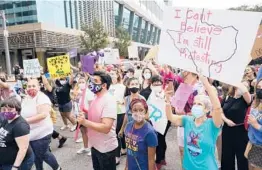  ?? MELISSA PHILLIP/HOUSTON CHRONICLE ?? People participat­e in the Houston Women’s March against Texas abortion ban walk Oct. 2 from Discovery Green to City Hall in Houston.