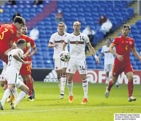  ??  ?? Neco Williams leaps highest to head in Wales’ injury-time winner against Bulgaria