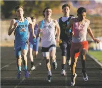  ?? CRAIG FRITZ/FOR THE NEW MEXICAN ?? Capital High School’s Lucas McNatt, left, finishes second during the four-by-200 relay at the Golden Spike Classic on Tuesday at Santa Fe High School.