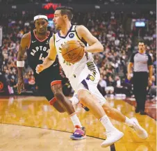  ??  ?? The Pacers’ T.J. Mcconnell drives past the Raptors’ Rondae Hollis-jefferson during Toronto’s 119-118 win on Wednesday. It was the 12th straight win for the Raptors, a team record. JOHN E. SOKOLOWSKI/USA TODAY SPORTS