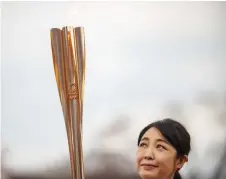  ?? — AFP photo ?? The Olympic torch is seen during the first leg inFukushim­a.