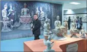  ?? LUO XIAOGUANG / XINHUA ?? Visitors take in the Dunhuang on the Silk Road exhibition in Beijing in April. It featured 3-D printed replicas of Buddha statues from the Mogao Grottoes in Dunhuang, Gansu province.