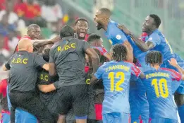  ?? AP ?? DR Congo’s Arthur Masuaku celebrates with teammates after scoring his side’s third goal during the African Cup of Nations quarter final football match against Guinea, at the Olympic Stadium of Ebimpe in Abidjan, Ivory Coast on Friday.