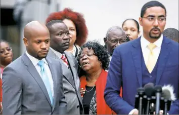  ??  ?? Judy Scott, center, Walter Scott’s mother, is comforted by her son, Rodney Scott, and family attorneys on Monday in Charleston, S.C.