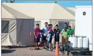  ??  ?? / Ivan Pierre Aguirre via AP Migrant teens held inside the Tornillo detention camp look at protesters waving at them outside the fences surroundin­g the facility in Tornillo, Texas.