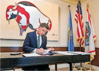  ?? [PHOTO BY CHRIS LANDSBERGE­R, THE OKLAHOMAN] ?? Oklahoma City Mayor David Holt works Thursday at his desk at City Hall. Holt has designated Oct. 8 as Indigenous Peoples Day in the city.