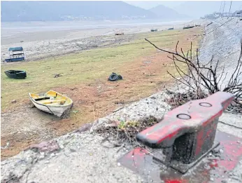  ??  ?? WASHED UP: The Jablanica lake recently reached the lowest recorded water level since 1955. The water is expected to rise again, but fishermen say it has already dramatical­ly depleted fish stocks.