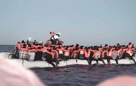  ?? AFP ?? Migrants being rescued before boarding SOS Mediterran­ee’s ship, Aquarius. The French NGO said it had received instructio­ns from the Italian Maritime Rescue Coordinati­on Centre to stand by in its current position between Italy and Malta.