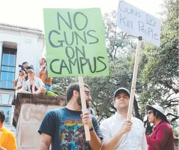  ??  ?? TAKING AIM: Texan students with signs and sex toys protest against concealed guns on campus.