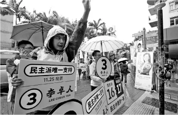  ??  ?? Supporters of Lee Cheuk-yan, a candidate for Hong Kong’s democratic camp, try to canvass votes for a crucial legislativ­e by-election on Sunday at the Mei Foo residentia­l estate, in Hong Kong. — Reuters photo