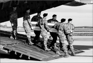  ?? ASSOCIATED PRESS ?? AN ARMY CARRY TEAM moves a transfer case containing the remains of U.S. Army Sgt. 1st Class Michael Goble, at Dover Air Force Base, Del. Goble, a U.S. Special Forces soldier who died in Afghanista­n this week, was seizing a Taliban weapons cache when he was killed, the U.S. military said.