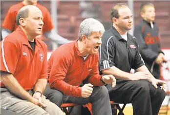  ?? DENISE SANCHEZ/THE MORNING CALL ?? (Left to right) Easton’s head coach, Steve Powell and assistant coaches Barry Snyder and Sean Richmond, react to a match in the first round of the PIAA 3A team wrestling championsh­ips held at the Giant Center on Thursday.