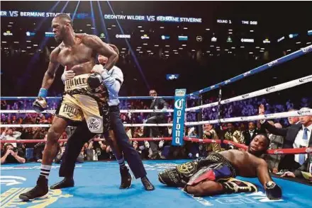  ?? AFP PIC ?? Deontay Wilder knocks out Bermane Stiverne in the first round during their rematch for Wilder’s WBC heavyweigh­t title on Saturday.