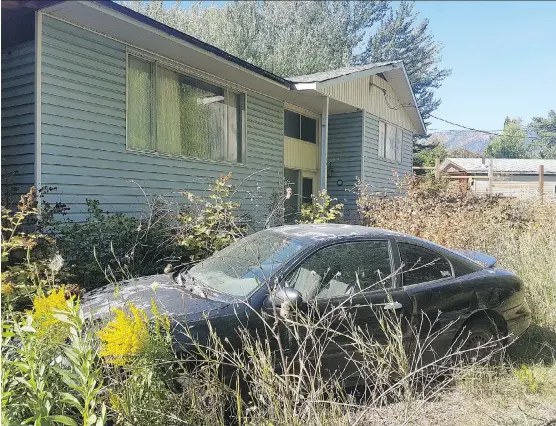  ?? PHOTOS: BETHANY LINDSAY ?? An abandoned car sits in front of Lacey LaRochelle’s home in Lillooet, B.C. The house was deemed uninhabita­ble after a series of landslides in 2011.