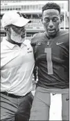  ?? MICHAEL HICKEY/GETTY ?? Coach Lovie Smith talks with quarterbac­k AJ Bush last week. Bush was hurt in the first quarter Saturday and left the game.